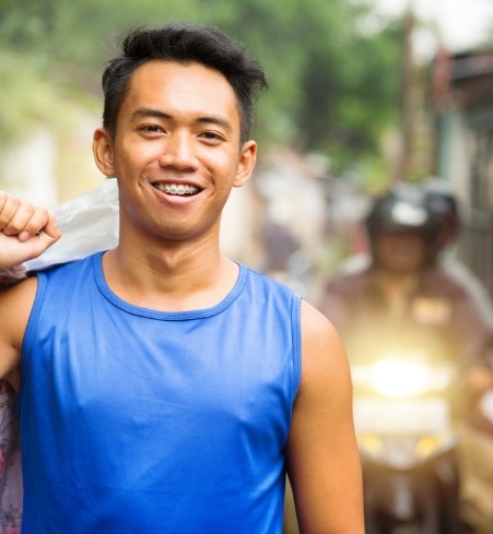 Smiling man with adult orthodontics in place