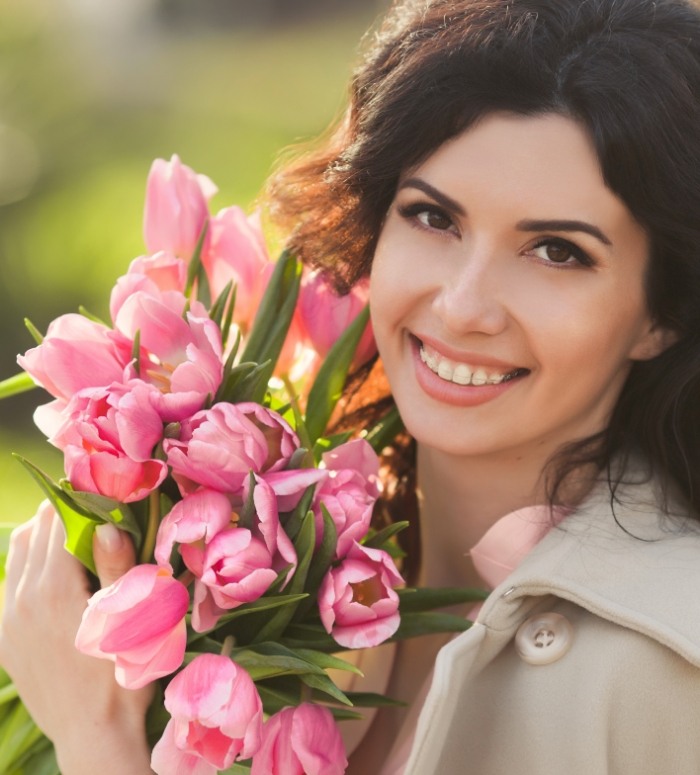 Smiling woman with clear and ceramic braces