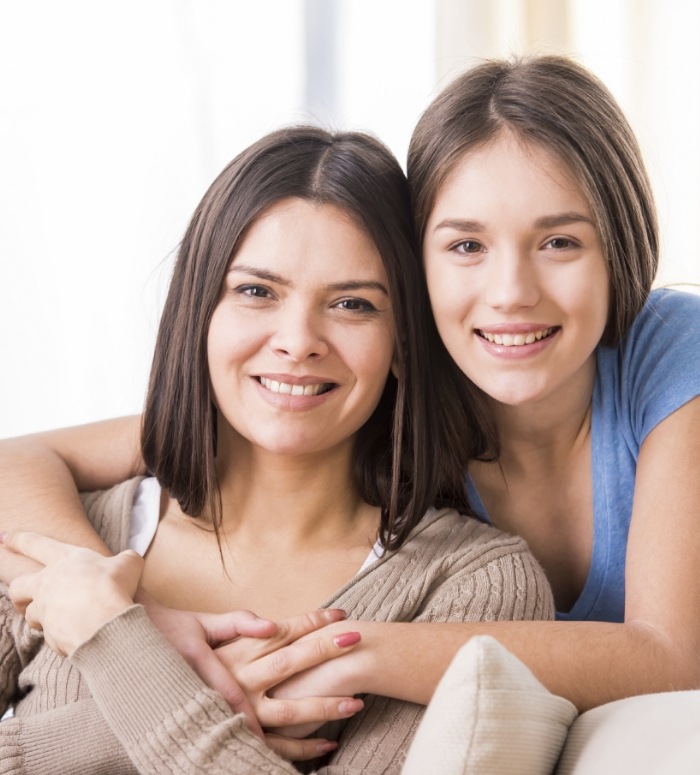 Mother and child smiling after dentofacial orthopedics treatment