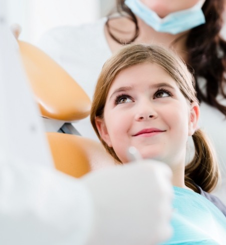 Young woman smiling during dentofacial orthopedics treatment