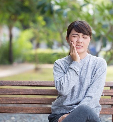 Woman experiencing oral pain and soreness