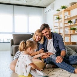 Parents and child smiling together