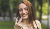 Smiling woman holding a clear braces tray