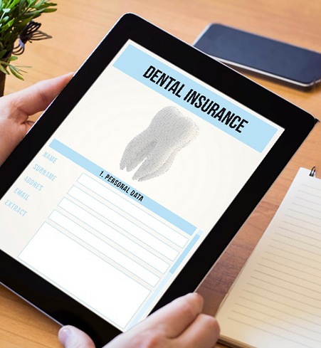 Patient looking at dental insurance forms on tablet