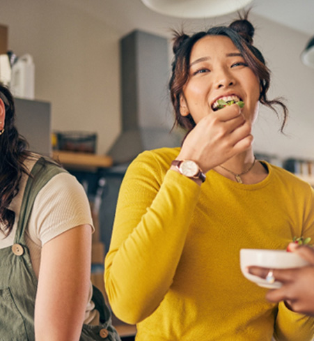 Group of friends smiling while eating together
