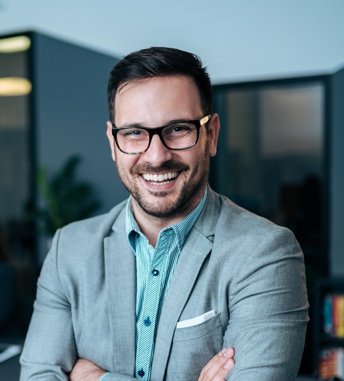 Man with perfectly aligned smile after Invisalign clear aligner treatment