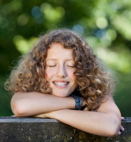 Smiling teen with orthodontic appliance