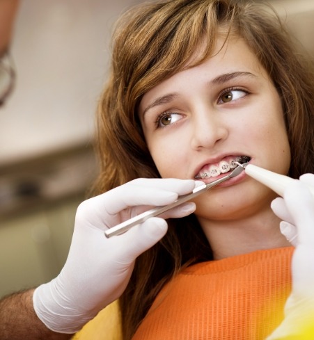 Orthodontist placing phase one pediatric orthodontic treatment