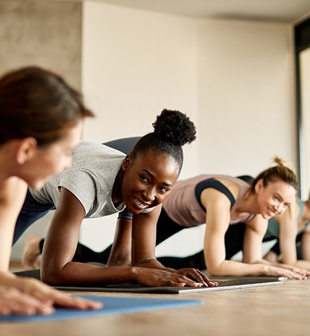 Group of women smiling during workout class