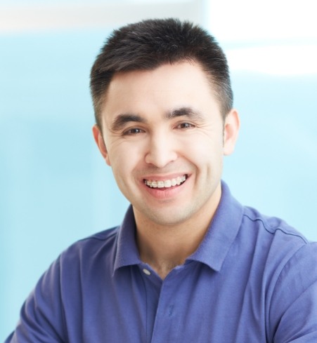 Man with traditional braces smiling