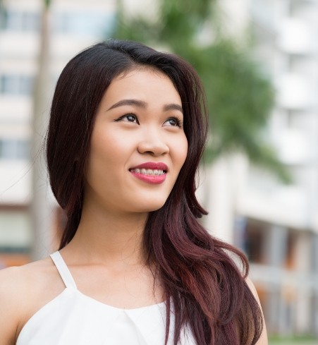 Woman with traditional braces smiling