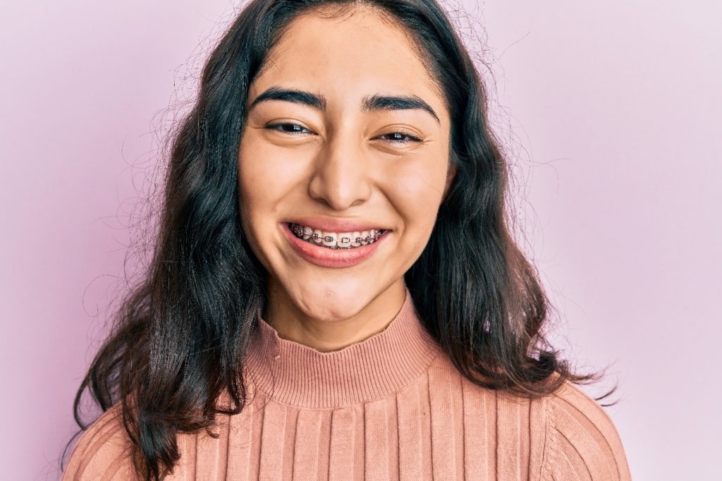 Closeup of young girl with braces smiling