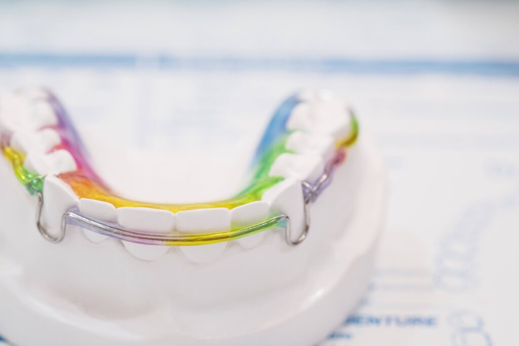 Colorful retainer on model of teeth