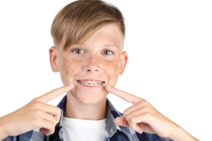 a child with braces smiling confidently